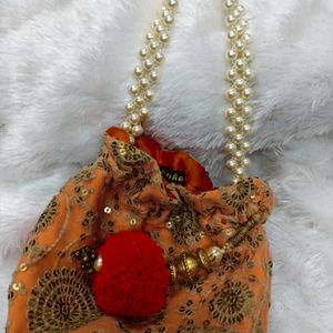 Radiant Elegance: Orange & Golden Potli Bag