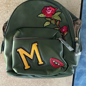 Olive Green Back Pack With Work On It