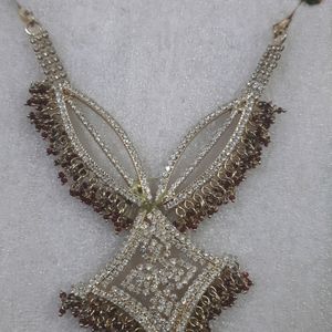 A Maroon golden Neckpiece