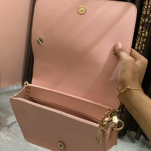 Baby pink sling bag.