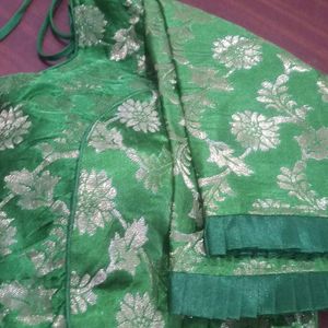 Green colour soft brocade padded blouse . It has princess cut in the front ruffles on sleeves