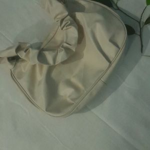 A Beige Side Bag.