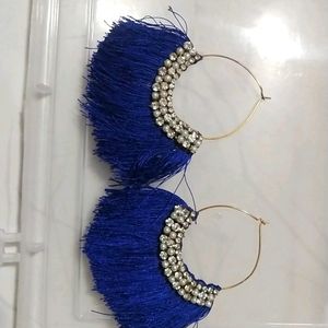 medium sized ear rings with blue threads