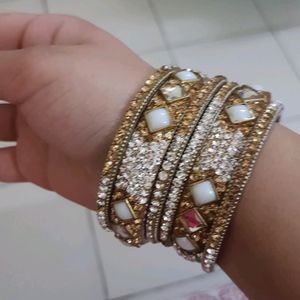 Stone Bangles Of White And Golden Color.