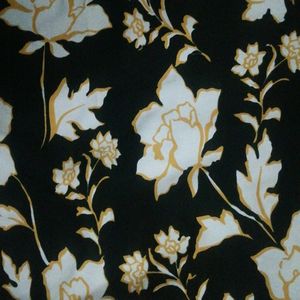 Black Crape Kurtha With  Yellow Border At Front.have White Flowers In It. Round Neck With 3/4 th Sleevs