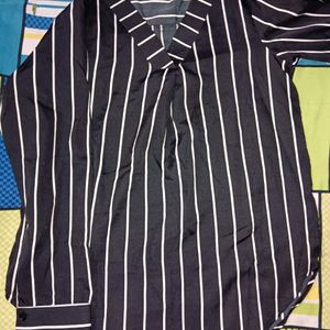 A White  Lined Top Over. Black Shirt