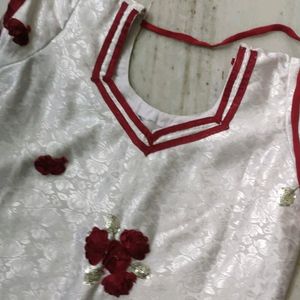 Elegant White Dress with Red Floral Embellishment