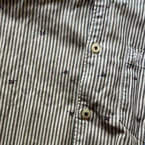 A Full Sleeve Shirt With Vertical Stripes.