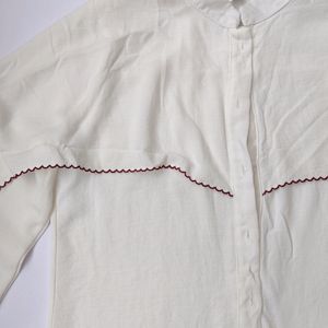 White shirt with red scallop detailing