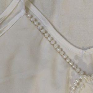 White top with pearl detail