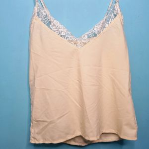 Cream Cami Top With Net Design On Neck.