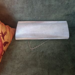 Silver Clutch. There are very few stains over it i