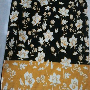 Black Crape Kurtha With  Yellow Border At Front.have White Flowers In It. Round Neck With 3/4 th Sleevs