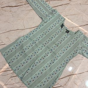 women pista green short kurta