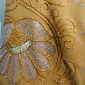 Cream And Orange Embroidery Saree