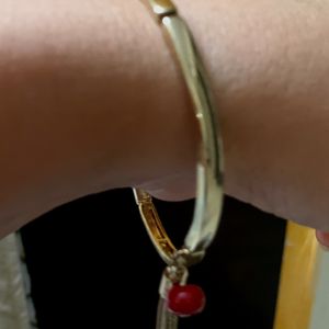 Elegant Metallic Bracelet With a Red Bead