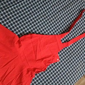 A Dungaree Dress In Bright Red