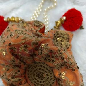 Radiant Elegance: Orange & Golden Potli Bag