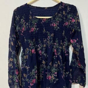 This is a navy blue long-sleeved blouse