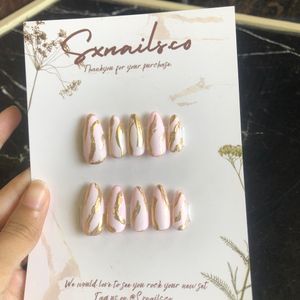 Pink presson nails with gold metallic strips