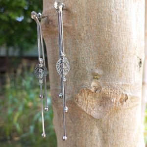 silver earrings with white stone .