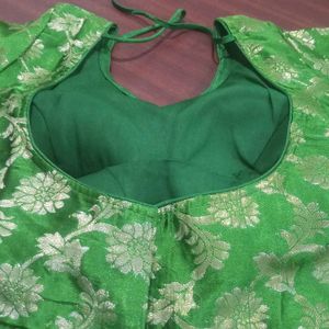 Green colour soft brocade padded blouse . It has princess cut in the front ruffles on sleeves