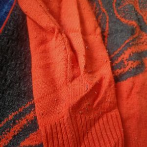 Orange Sweater With Black Print  . Lightly Lint On This