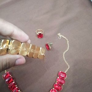 red necklace with earings, bracelet, ring