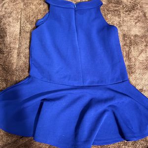 A Peplum Top With Lace Detail On Neck