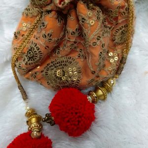 Radiant Elegance: Orange & Golden Potli Bag