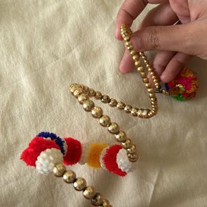 golden bracelets with pompom