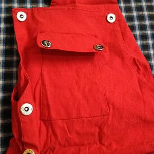 A Dungaree Dress In Bright Red