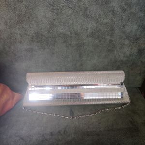 Silver Clutch. There are very few stains over it i