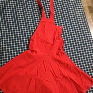 A Dungaree Dress In Bright Red