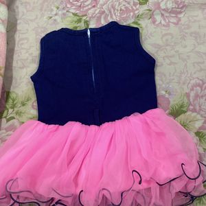 Baby girl party wear frock with pink net in bottom And blue jean upper side,suitable for 1-1.5 yrbaby girl,has button In front and has soft net,baby will be comfortable in this cloth,has zip in back