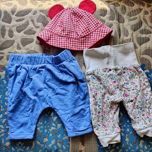 Mothercare joggers (set of 2) and a baby cap.