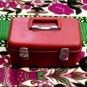 IT IS RED COLOR MAKEUP PLASTIC VANITY BOX......