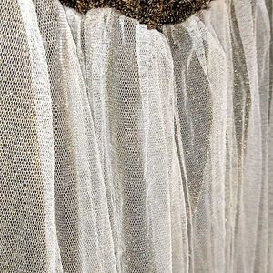 A Skirt In Net Metalic Gold Colour With Whitenet