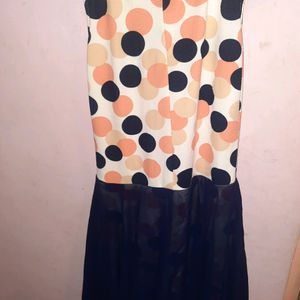 knee length dress,sleevelesswith added flares ..lovely multicoloured polka with round  necklace design.back zipper is invincible