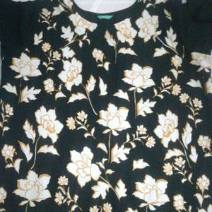 Black Crape Kurtha With  Yellow Border At Front.have White Flowers In It. Round Neck With 3/4 th Sleevs