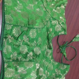 Green colour soft brocade padded blouse . It has princess cut in the front ruffles on sleeves