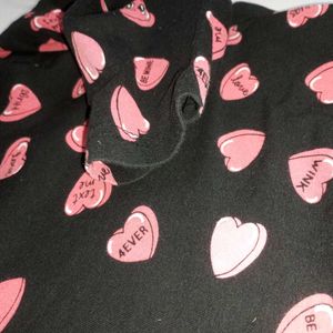 Chic Black Sleeveless Top with Playful Heart Print