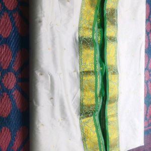 White Saree With Green And Golden Design