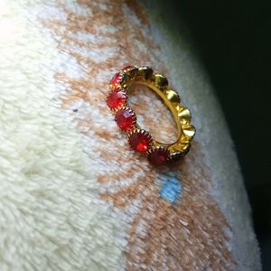 A Beautiful Golden Ring With Red Diamonds