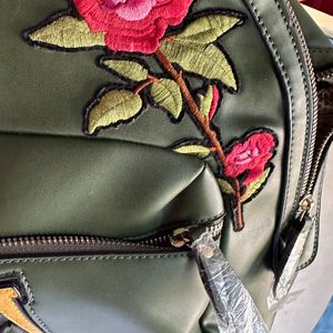 Olive Green Back Pack With Work On It