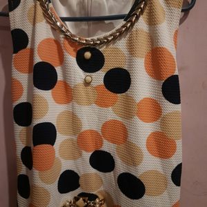 knee length dress,sleevelesswith added flares ..lovely multicoloured polka with round  necklace design.back zipper is invincible