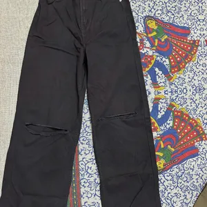 Black Flared Jeans With Cutout Detail