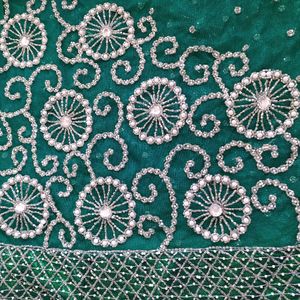 bottle green net saree with blouse and lehnga