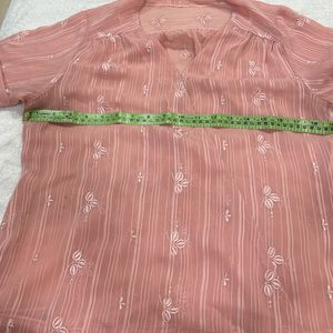 A Pretty Peach Top With Delicate Embroidered Motif