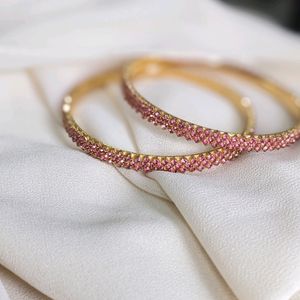 A Rose Gold Bangle With Ros Stones